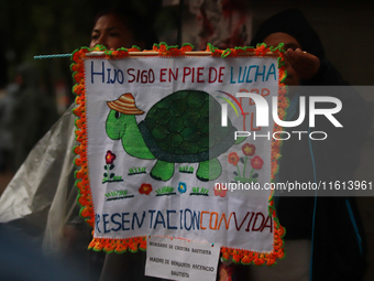 A person takes part in a protest in support of the parents of the rural student victims to demand justice during the 10th anniversary of the...