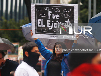 A person holds a white placard during a protest in support of the parents of the rural student victims to demand justice on the 10th anniver...