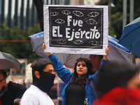 A person holds a white placard during a protest in support of the parents of the rural student victims to demand justice on the 10th anniver...