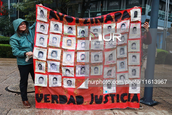 A person takes part in a protest in support of the parents of the rural student victims to demand justice during the 10th anniversary of the...