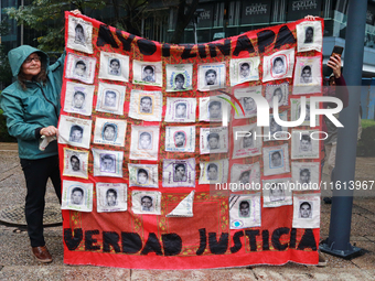 A person takes part in a protest in support of the parents of the rural student victims to demand justice during the 10th anniversary of the...