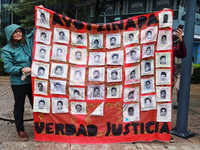 A person takes part in a protest in support of the parents of the rural student victims to demand justice during the 10th anniversary of the...