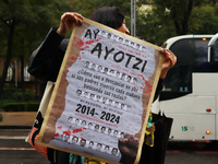 A person holds a white placard during a protest in support of the parents of the rural student victims to demand justice on the 10th anniver...