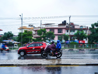 People's daily lives are affected by the heavy rainfall in Kathmandu, Nepal, on September 27, 2024. People wear raincoats and travel to thei...