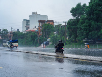 People's daily lives are affected by the heavy rainfall in Kathmandu, Nepal, on September 27, 2024. People wear raincoats and travel to thei...