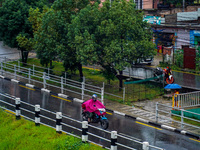 People's daily lives are affected by the heavy rainfall in Kathmandu, Nepal, on September 27, 2024. People wear raincoats and travel to thei...