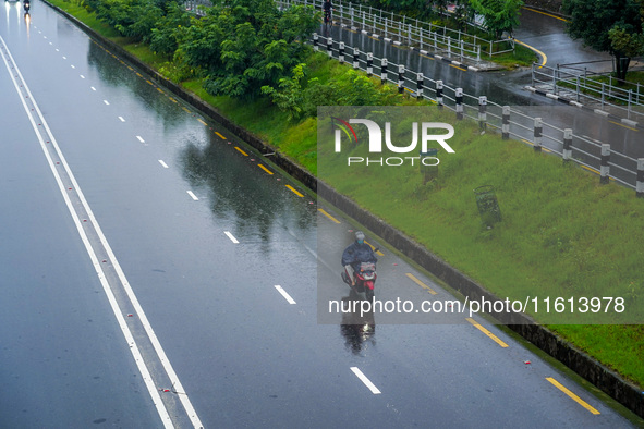 People's daily lives are affected by the heavy rainfall in Kathmandu, Nepal, on September 27, 2024. People wear raincoats and travel to thei...