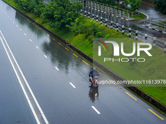 People's daily lives are affected by the heavy rainfall in Kathmandu, Nepal, on September 27, 2024. People wear raincoats and travel to thei...