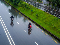 People's daily lives are affected by the heavy rainfall in Kathmandu, Nepal, on September 27, 2024. People wear raincoats and travel to thei...