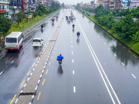 People's daily lives are affected by the heavy rainfall in Kathmandu, Nepal, on September 27, 2024. People wear raincoats and travel to thei...