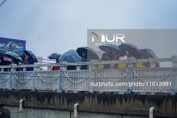 People's daily lives are affected by the heavy rainfall in Kathmandu, Nepal, on September 27, 2024. People use umbrellas and travel to their...