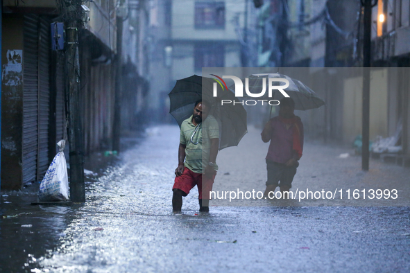 People wade through the flood water in Kathmandu, Nepal, on September 27, 2024. The Himalayan nation witnesses downpour after the activation...