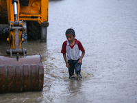 A Nepali boy wades through the flood water in Kathmandu, Nepal, on September 27, 2024. The Himalayan nation witnesses downpour after the act...