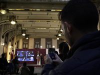 A reporter takes pictures of Andres Manuel Lopez Obrador, president of Mexico, during his penultimate press conference at the National Palac...