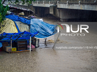 The Bagmati River floods and affects the riverbanks and homes during heavy rainfall in Kathmandu, Nepal, on September 27, 2024. (