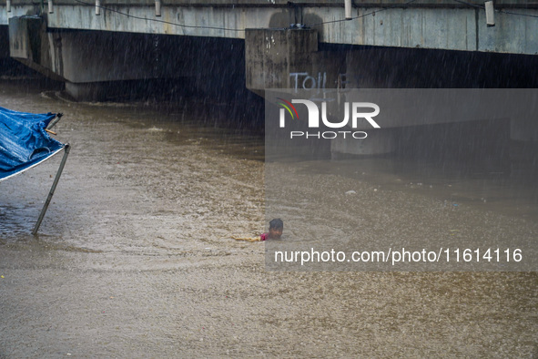 People's daily lives are affected due to heavy rainfall and flooding of the Bagmati River in Kathmandu, Nepal, on September 27, 2024. 