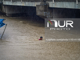 People's daily lives are affected due to heavy rainfall and flooding of the Bagmati River in Kathmandu, Nepal, on September 27, 2024. (