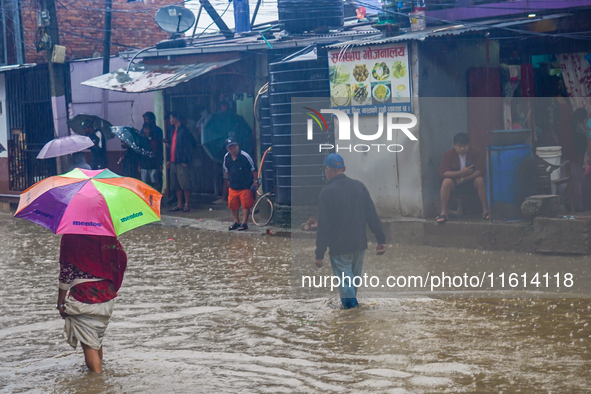 People's daily lives are affected due to heavy rainfall and flooding of the Bagmati River in Kathmandu, Nepal, on September 27, 2024. 