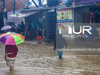 People's daily lives are affected due to heavy rainfall and flooding of the Bagmati River in Kathmandu, Nepal, on September 27, 2024. (