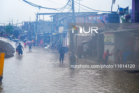 People's daily lives are affected due to heavy rainfall and flooding of the Bagmati River in Kathmandu, Nepal, on September 27, 2024. 