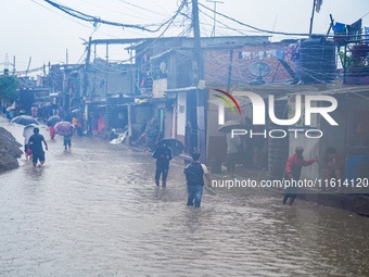 People's daily lives are affected due to heavy rainfall and flooding of the Bagmati River in Kathmandu, Nepal, on September 27, 2024. (