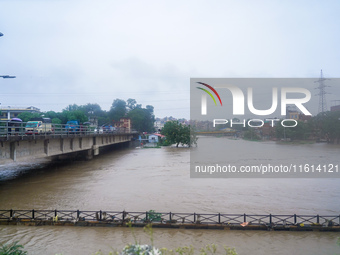 The Bagmati River floods and affects the riverbanks and homes during heavy rainfall in Kathmandu, Nepal, on September 27, 2024. (