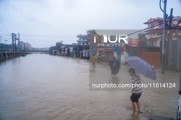 People's daily lives are affected due to heavy rainfall and flooding of the Bagmati River in Kathmandu, Nepal, on September 27, 2024. 