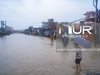 People's daily lives are affected due to heavy rainfall and flooding of the Bagmati River in Kathmandu, Nepal, on September 27, 2024. (