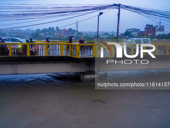 The Bagmati River floods and affects the riverbanks and homes during heavy rainfall in Kathmandu, Nepal, on September 27, 2024. (