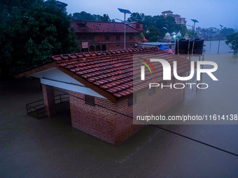 The Bagmati River floods and affects the riverbanks and homes during heavy rainfall in Kathmandu, Nepal, on September 27, 2024. (