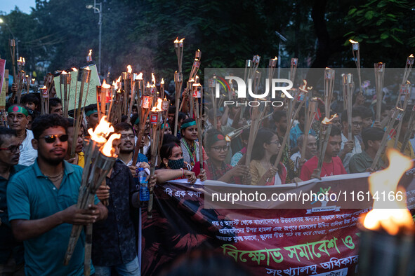 The Hindu community holds demonstrations and torchlight processions to protest the attacks, looting, vandalism, and arson targeting temples...