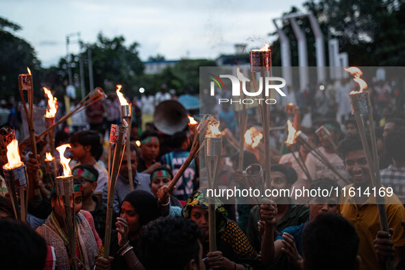 The Hindu community holds demonstrations and torchlight processions to protest the attacks, looting, vandalism, and arson targeting temples...