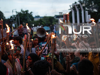 The Hindu community holds demonstrations and torchlight processions to protest the attacks, looting, vandalism, and arson targeting temples...