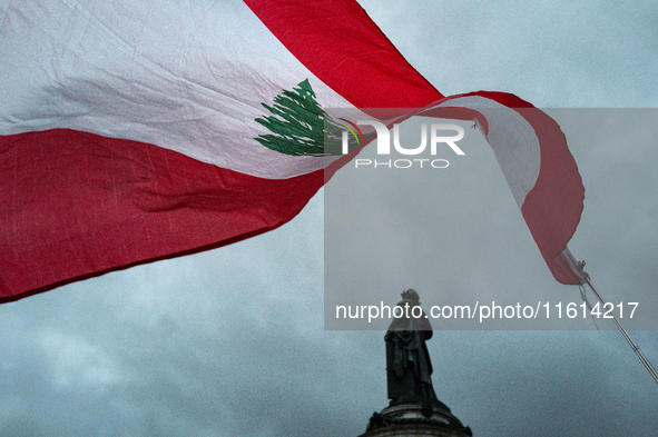 A demonstrator holds a Lebanese flag during a gathering called in support of Lebanon, in Paris, France, on September 27, 2024, in solidarity...