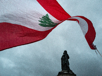 A demonstrator holds a Lebanese flag during a gathering called in support of Lebanon, in Paris, France, on September 27, 2024, in solidarity...