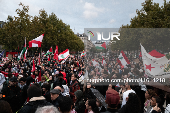 Demonstrators hold Palestinian and Lebanese flags during a gathering called in support of Lebanon, in Paris, France, on September 27, 2024....