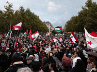 Demonstrators hold Palestinian and Lebanese flags during a gathering called in support of Lebanon, in Paris, France, on September 27, 2024....