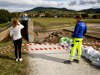 Visitors look at the broken dam that added to the scale of massive flooding in southern Poland is seen in tourist resorts in southern Poland...