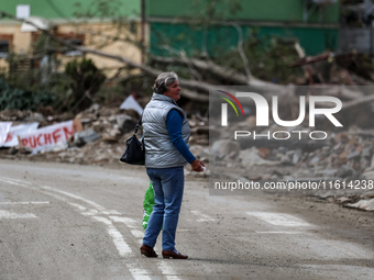 A woman walks pass debris of destroyed  buildings are seen  as massive flooding affected tourist resorts in southern Poland - Stronie Slaski...