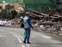 A woman walks pass debris of destroyed  buildings are seen  as massive flooding affected tourist resorts in southern Poland - Stronie Slaski...