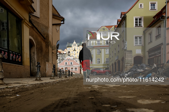 A man walks pass debris from destroyed  buildings as massive flooding affected tourist resorts in southern Poland - Klodzko, Poland on Septe...