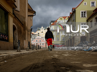 A man walks pass debris from destroyed  buildings as massive flooding affected tourist resorts in southern Poland - Klodzko, Poland on Septe...