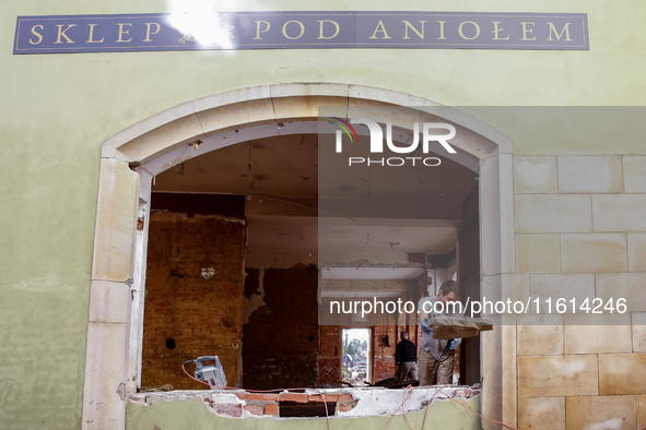 A man warks in destroyed shop as massive flooding affected tourist resorts in southern Poland - Klodzko, Poland on September 27, 2024. Centr...