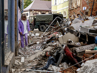 A woman walks pass debris from destroyed  buildings as massive flooding affected tourist resorts in southern Poland - Klodzko, Poland on Sep...