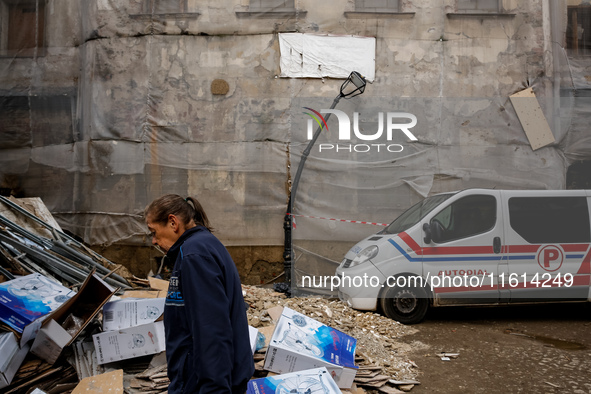 A woman walks pass debris from destroyed  buildings as massive flooding affected tourist resorts in southern Poland - Klodzko, Poland on Sep...