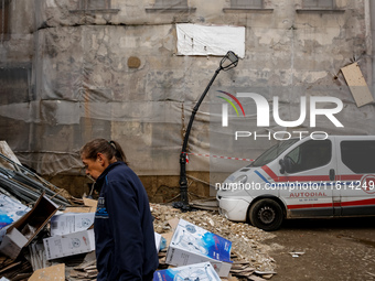 A woman walks pass debris from destroyed  buildings as massive flooding affected tourist resorts in southern Poland - Klodzko, Poland on Sep...