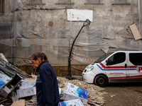 A woman walks pass debris from destroyed  buildings as massive flooding affected tourist resorts in southern Poland - Klodzko, Poland on Sep...