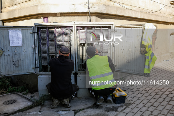 Electritians fix residential building electricity as massive flooding affected tourist resorts in southern Poland - Klodzko, Poland on Septe...