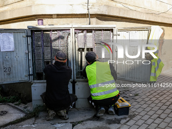 Electritians fix residential building electricity as massive flooding affected tourist resorts in southern Poland - Klodzko, Poland on Septe...