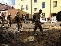 Military servicemen walk pass debris from destroyed  buildings as massive flooding affected tourist resorts in southern Poland - Klodzko, Po...